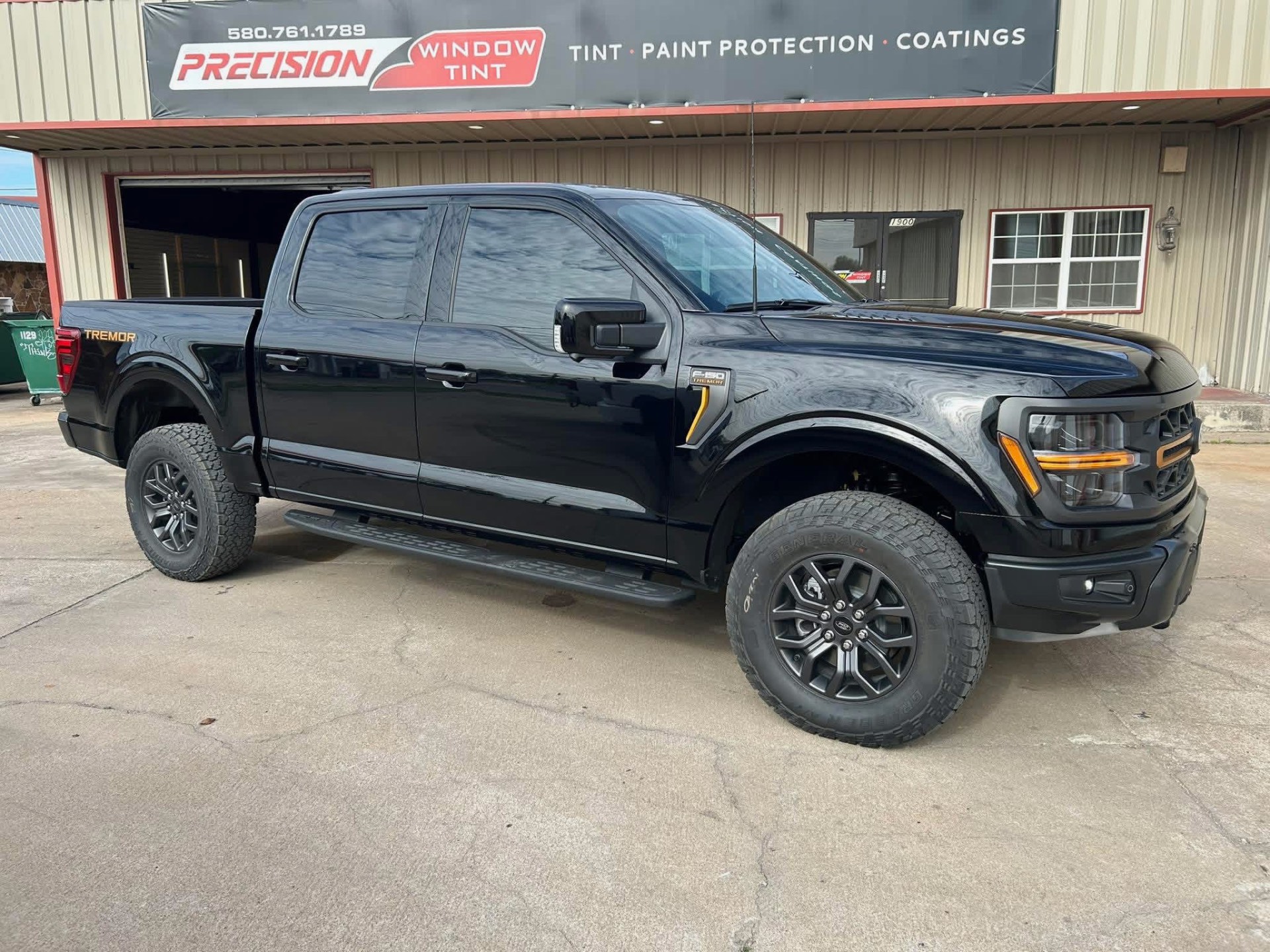 Blacked-out Ford F-150 Tremor with limo dark window tint at Precision Window Tint Ponca City OK